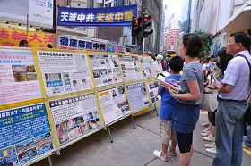 香港维多利亚公园附近的真相展板点,许多民众驻足观看法轮功真相