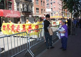 '七十九岁的但碧汉女士(右一)向路人讲法轮功真相'