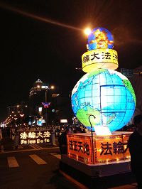 '“法轮大法洪传全世界”的地球花灯引领天国乐团行进,声势浩大'