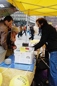 '风雨中人们驻足了解真相,签名反迫害'