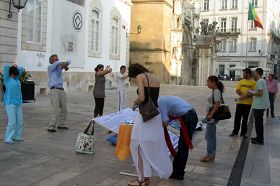 Coimbra的民众看真相展板和演示功法,签名支持反迫害