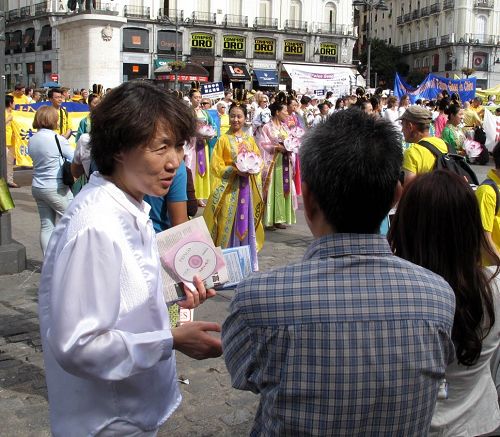 图5-6:在太阳门广场法轮功反迫害集会现场,法轮功学员向驻足观看的华人讲真相劝三退