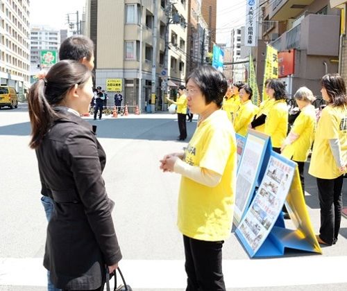 日本大阪中领馆前,法轮功学员给路人讲真相