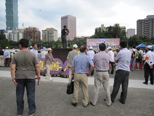 图4-6:有的民众情不自禁地站在法轮功学员旁边自己学起了功法,有的大陆游客流连忘返驻足许久舍不得离去。