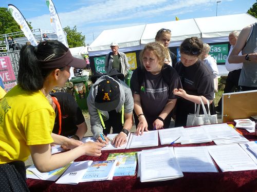 丹麦“人民聚会”活动期间,民众签名支持法轮功反迫害