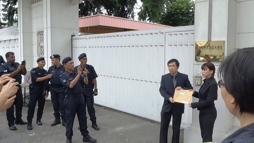 图3:法轮功学员代表到中共驻马大使馆递交抗议信,引起了许多官员的关注。
