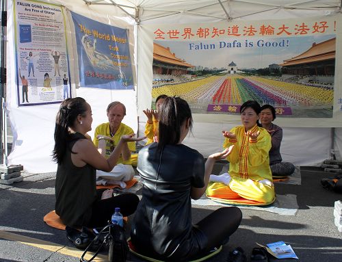 图6:两个姐妹被学员们展示的祥和的五套功法吸引,请学员指导学炼第五套功法。