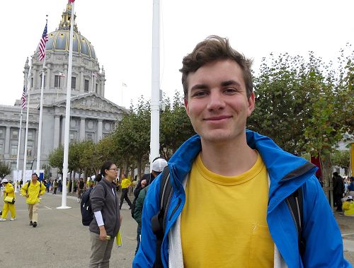'图5:德国法轮功学员Tobias Piastowski很高兴游行沿途观看的民众非常乐意接受法轮功的真相资料。'