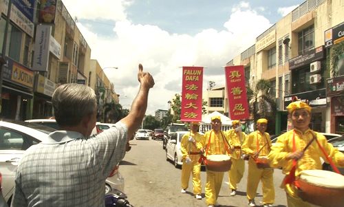 图11:老居民在路旁竖起拇指,不停的赞叹“好!好!好!”。