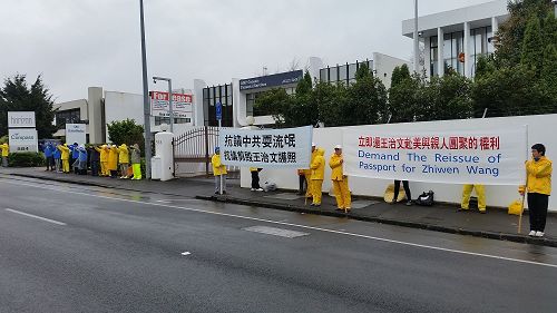 '图:奥克兰的法轮功学员打出“抗议中共耍流氓,抗议剪毁王治文护照”以及“立即还王治文赴美与亲人团聚的权利”等横幅,并在舒缓的音乐中炼功,无声地表达抗议。'