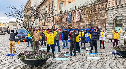 '图1:十一月二十五日中午,来自瑞典各地的法轮功学员集聚在位于瑞典国会大厦和皇宫之间的钱币广场上,举办了揭露中共迫害、讲真相活动。'
