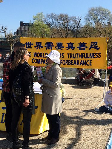 图3:法轮功学员在和驻足的民众交谈,传播真相