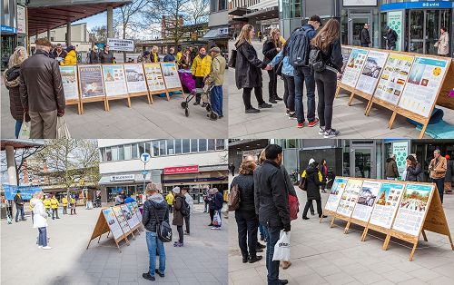 '图3:人们正在仔细阅读法轮功真相展板。'