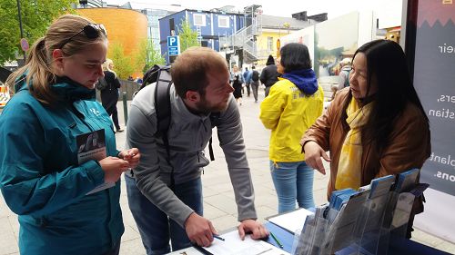 图1-5:在芬兰首都举办一年一次的世界村大型夏日活动上洪法,人们签名支持法轮功