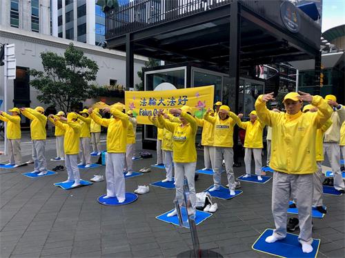 '图1:法轮功学员在奥克兰天空城炼功、讲真相。'