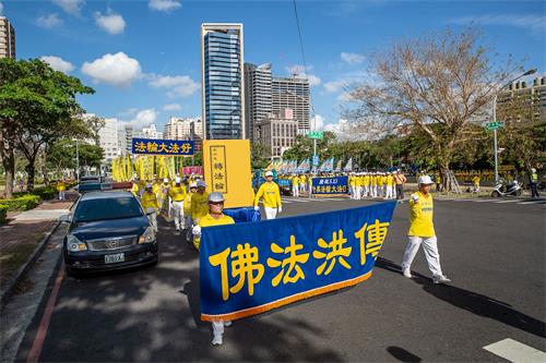 '图3:游行队伍展示巨大《转法轮》书模型,耀眼夺目。'