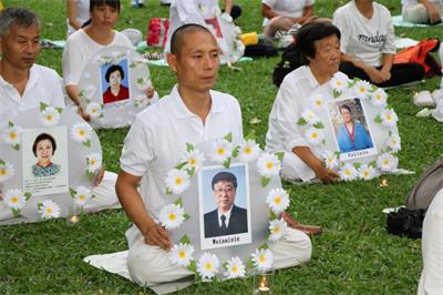 '图:2018年7月15日魏敏在泰国“7.20法轮功反迫害”集会现场,悼念被中共迫害致死的同修。'