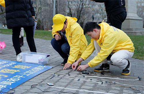 '图6:小孙(带黄色帽子)在布置会场'