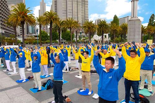 '图19:游行前,法轮功学员在渡轮大厦前广场炼功。'