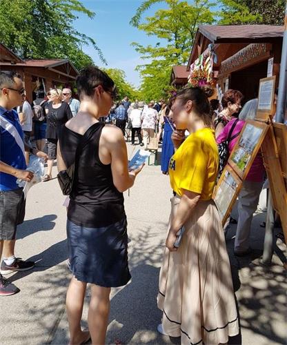 '图3:不断有游人前来了解法轮功真相'