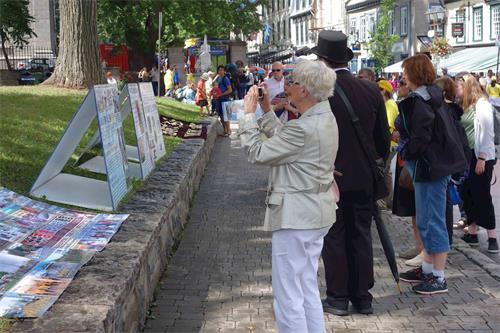 '图6~13:人们驻足观看真相展板,拍照,并和法轮功学员交谈'