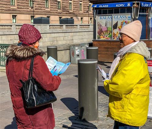 '图2:面对面向路人讲述什么是法轮功、中共造谣污蔑法轮功及活摘人体器官牟取暴利的事实真相。'