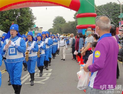 '图5:民众驻足观赏法轮大法天国乐团的表演。'