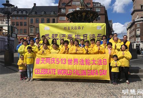 '图1:丹麦法轮功学员在哥本哈根市中心的老广场合影,庆祝第二十二届世界法轮大法日并恭贺师父七十华诞'