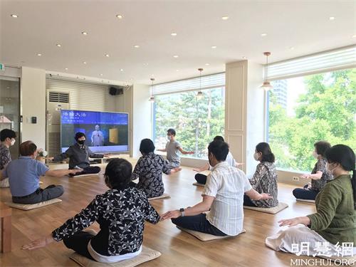 '图1:韩国首尔天梯书店法轮大法九天班(上午班)的学员正在学习法轮功炼功动作。'