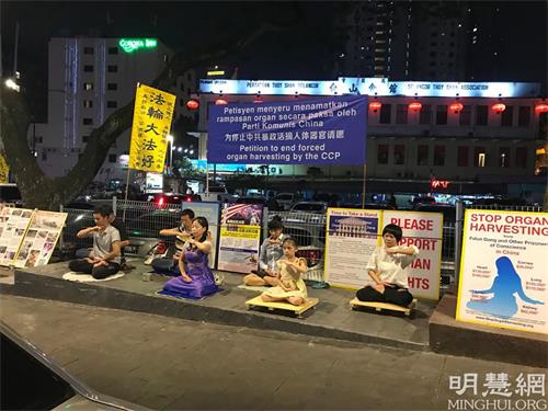 '图1:法轮功学员在马来西亚吉隆坡的亚罗街人行道上设立的真相点。'