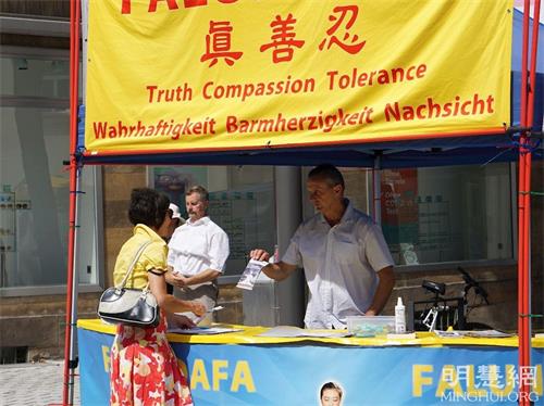 '图1~4:二零二一年八月十五日,在德国巴伐利亚州的拜罗伊特市(Bayreuth)举行瓦格纳歌剧节期间,法轮功学员的功法展示和真相展位吸引市民和来自世界各地的瓦格纳歌剧迷驻足,很多人签名反迫害。'