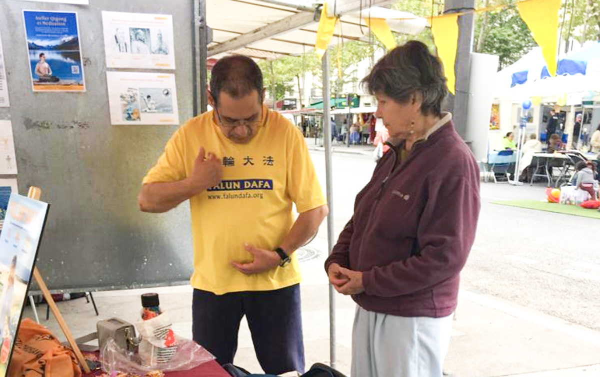 图5:民众在展位前学炼法轮功功法