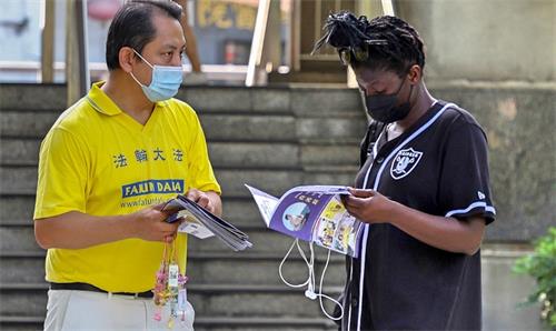 图3:一位来自哥斯达黎加的女士跟学员长谈,了解真相,并表示会去阅读《转法轮》。