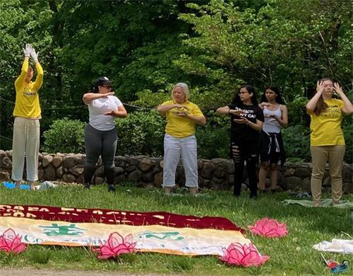 图14:劳拉(中)现场教感兴趣的民众第一套功法