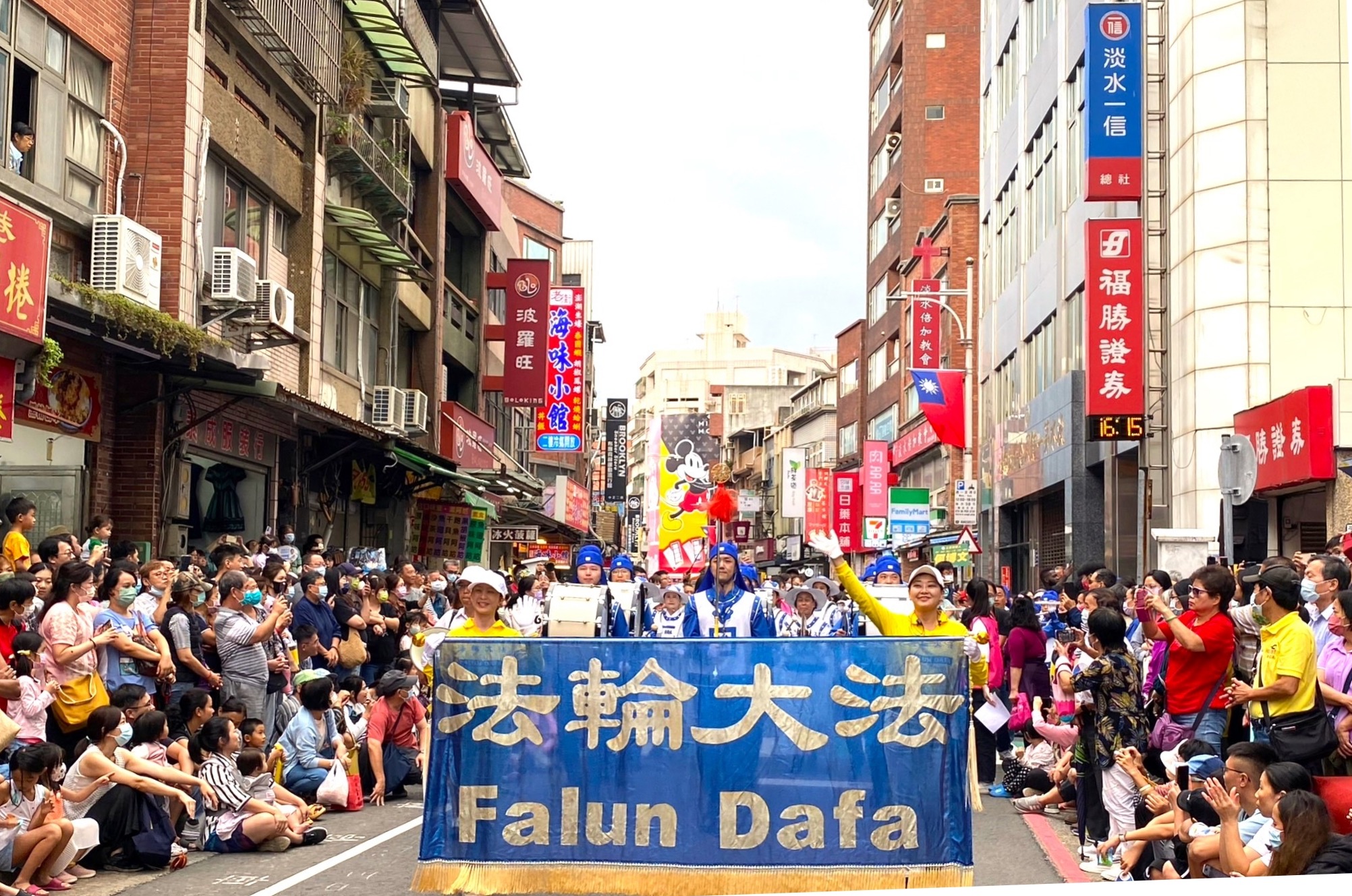 图1:二零二三年十月十四日,法轮功学员组成的天国乐团参加了台湾新北市的“淡水环境艺术节”踩街活动,受到两旁观众的欢迎。