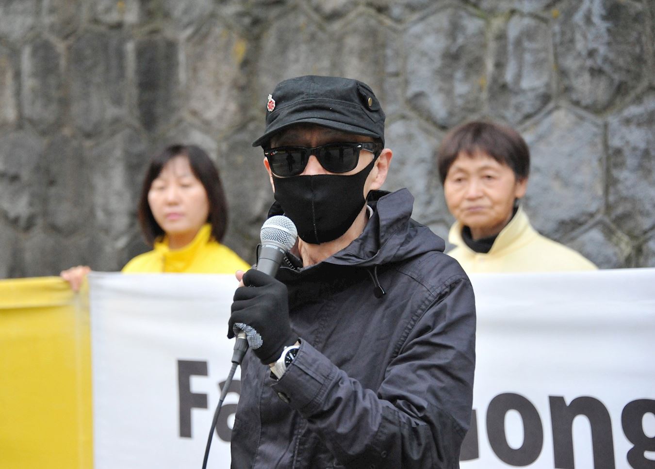 '图7:香港移民John在集会上发言说:“希望法轮功能够坚持下去,散发这个(善的)种子给每一个人”'