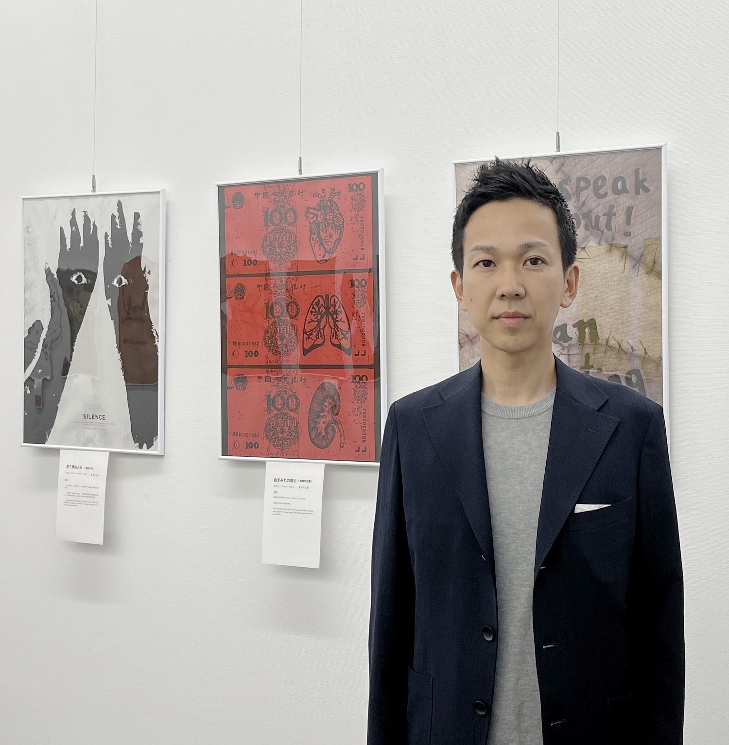 图3:东广岛市议员山田学仔细观看了每一幅作品