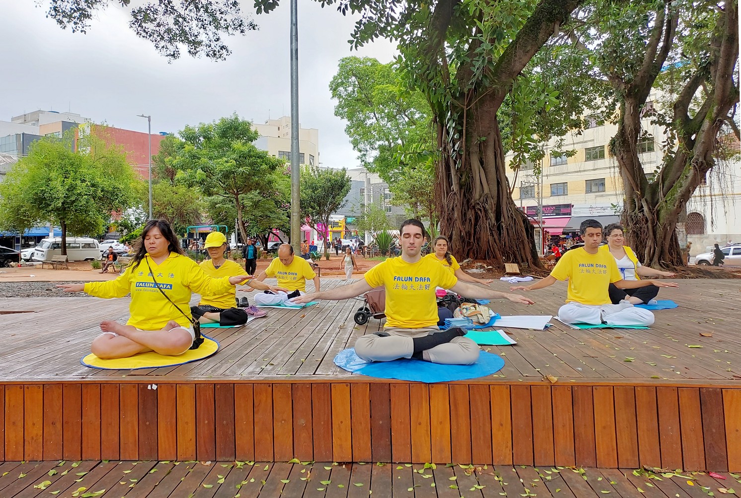 图5~6:员们在布拉斯的一个小广场挂上横幅集体炼功,向市民传递法轮大法的美好,并揭露中共迫害法轮功的真相。
