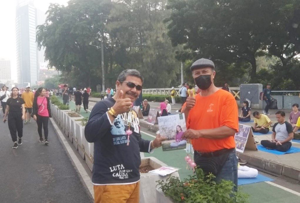 '图3:人们在资料点拿到法轮大法的资讯。'