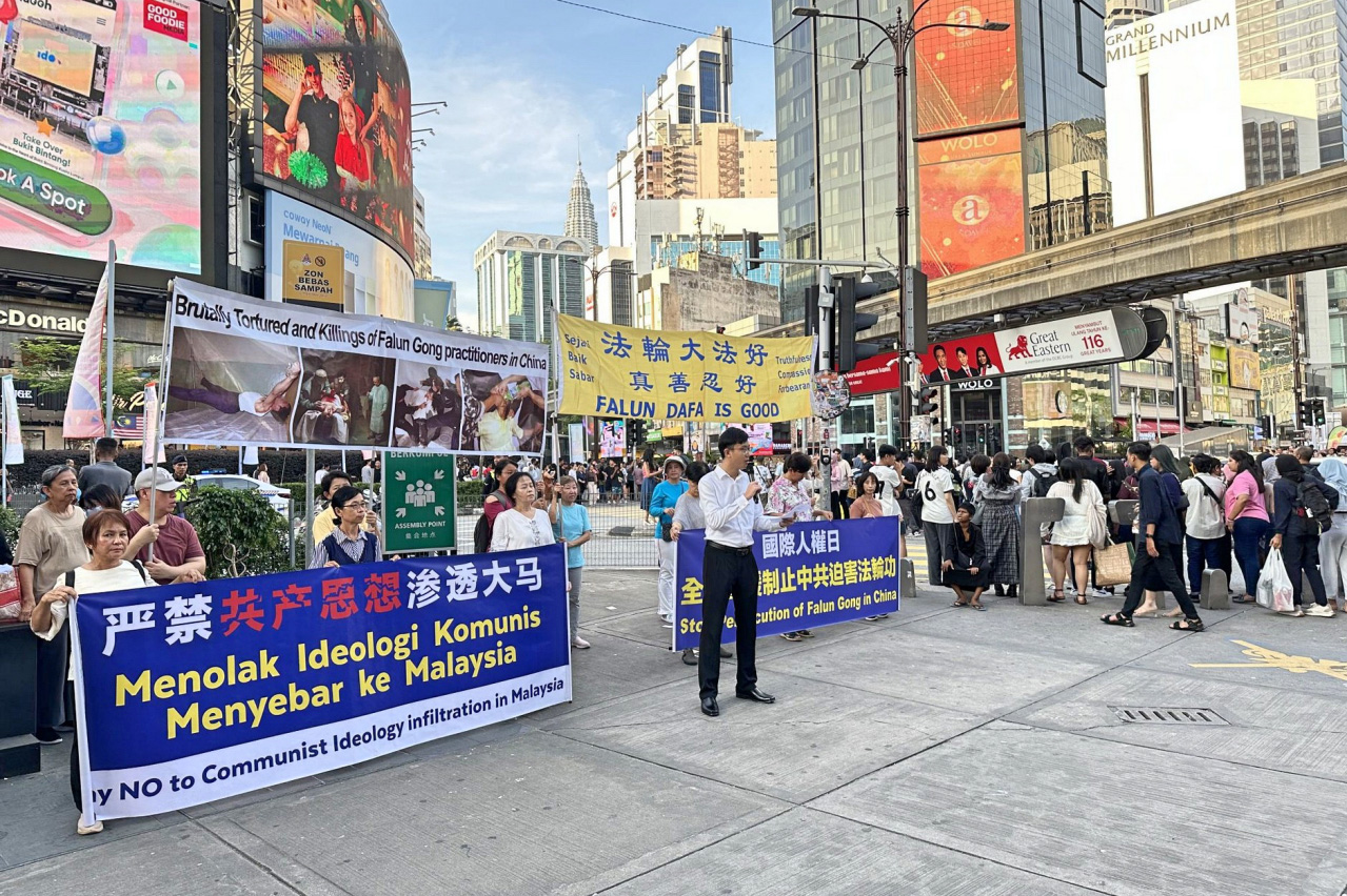 图3:2024年12月7日,马来西亚部份法轮功学员来到首都吉隆坡市中心武吉免登繁忙地段举行反迫害集会并宣读文稿。