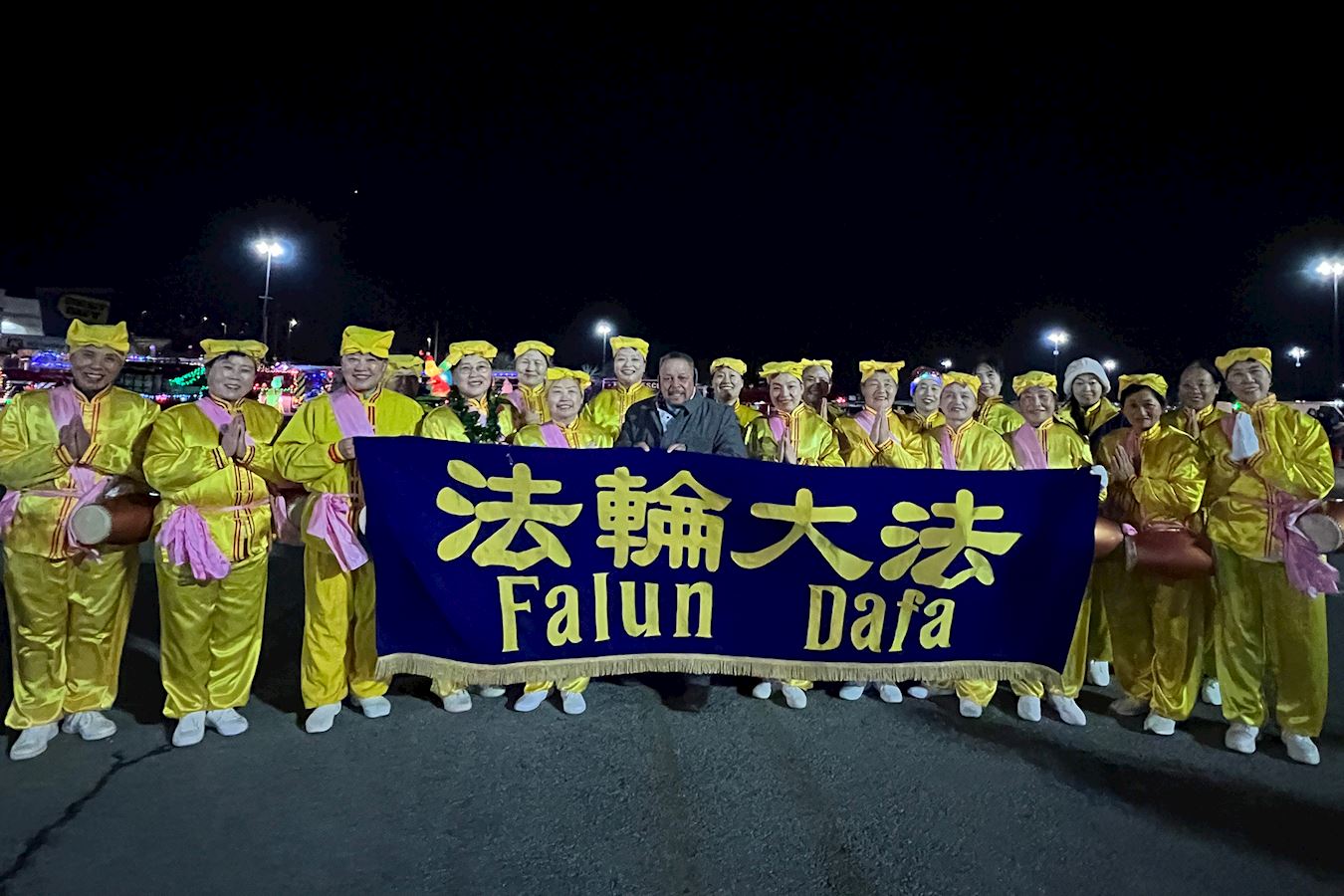 '图19:11月30日,纽约上州的沃尔基尔举行盛大的圣诞点灯活动。图为镇长塞拉诺与腰鼓队成员合影。'
