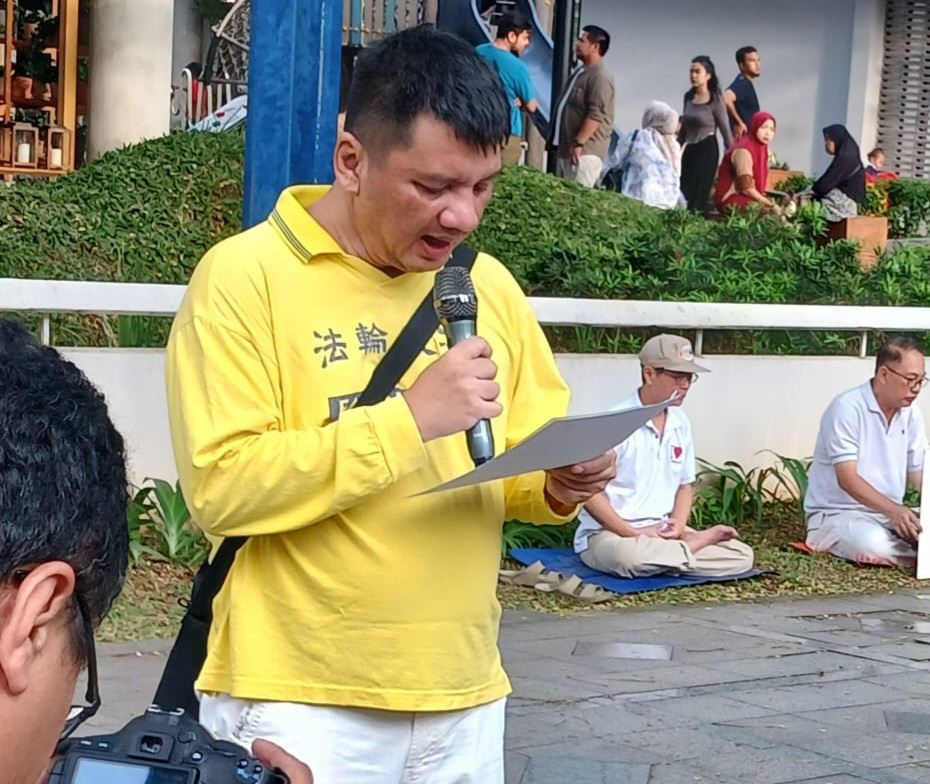 '图3:法轮功学员普利曼达喇(Primantara)在雅加达的中国驻印尼大使馆前阅读印尼佛学会的媒体公告'