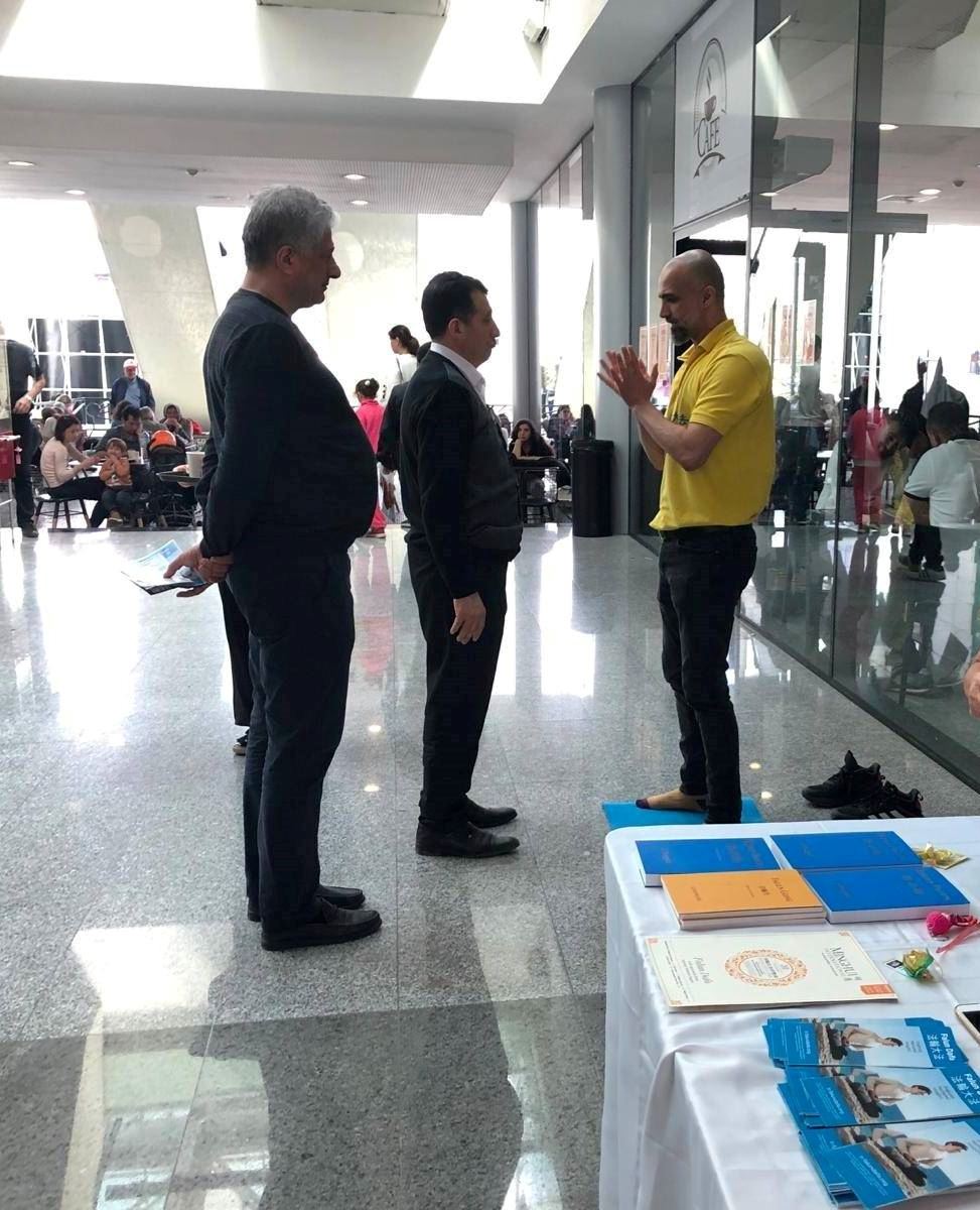 '图2:侯赛因先生(中)与朋友和法轮功学员交谈,了解法轮功真相。'