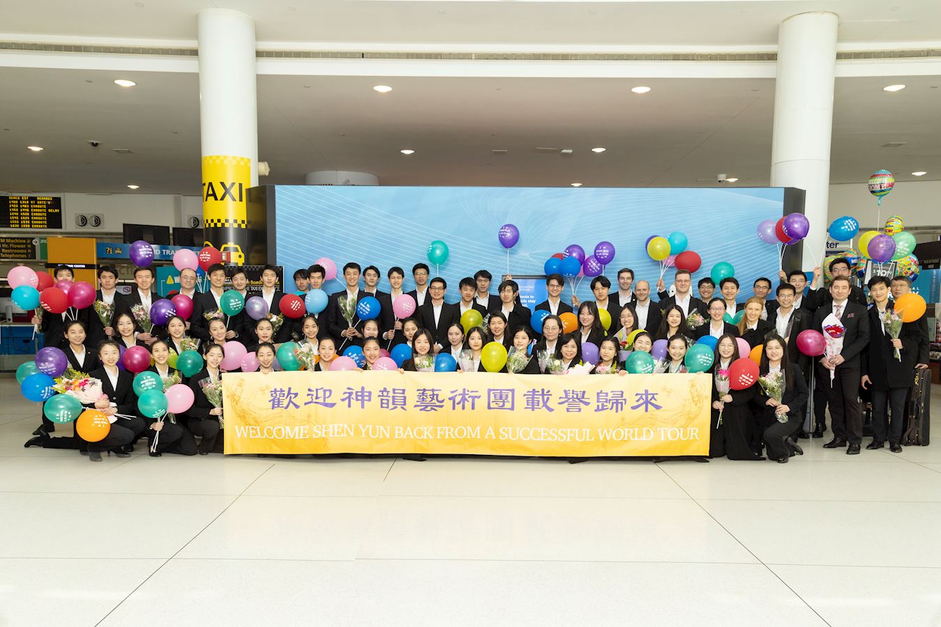 '图7:二零二四年五月十一日,神韵世界艺术团的艺术家们从欧洲演出归来,在纽约肯尼迪机场受到观众的热情欢迎。(大纪元)'