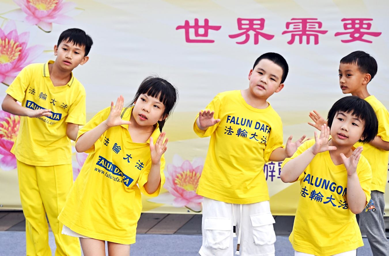 '图13:大法小弟子熟稔的背诵《洪吟二》〈坚定〉、〈无题〉、〈见真性〉等李洪志师父的诗作,及演唱《法轮大法好让全世界知道》。'
