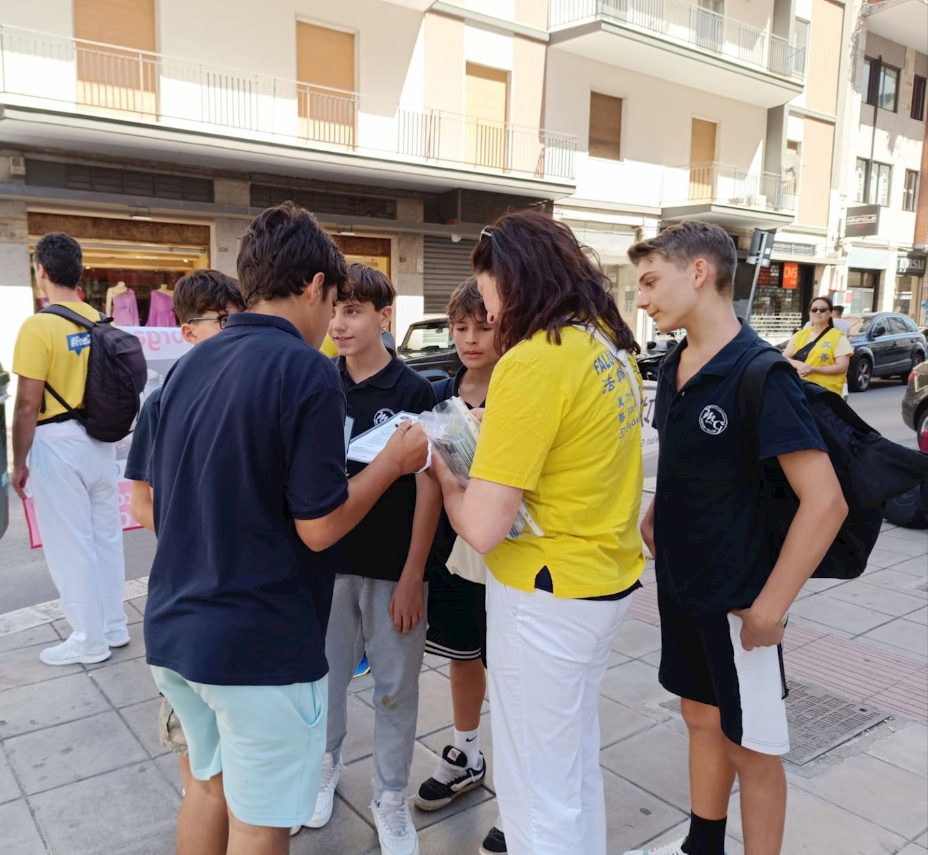 '图13:一群青少年詢問学员想了解更多的真相信息。'