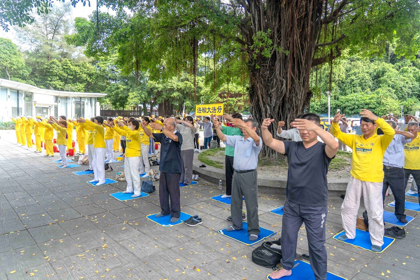'图1~4:二零二四年七月七日下午,高雄部份法轮功学员来到莲池潭景点弘法传真相,活动包括腰鼓队表演和五套功法演示,祥和的炼功场面吸引不少民众驻足观看。'