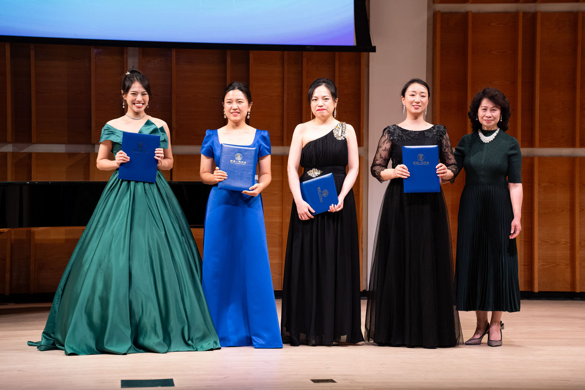 图5:在新唐人第九届全世界华人美声声乐大赛颁奖仪式上,新唐人大赛总监露西(Lucy Zhou)向优秀奖得主颁奖后合影。